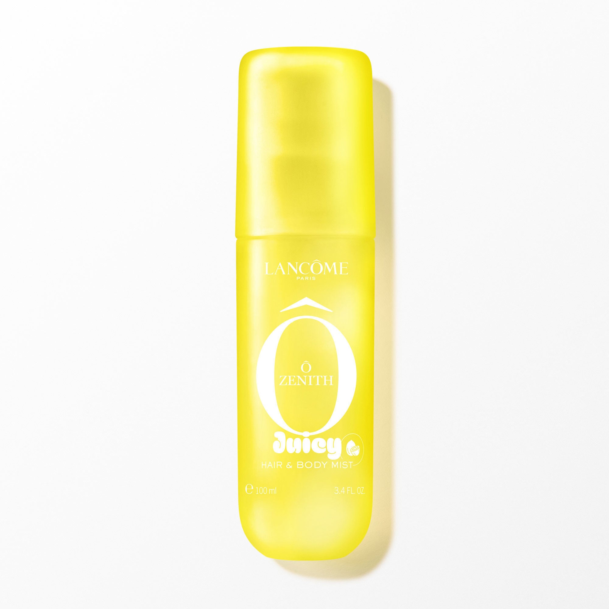 A yellow transparent spray bottle with a soft touch finish, containing a clear liquid, with white text on the front. The bottle is positioned vertically in the center, casting a subtle shadow on the white background. The image is brightly lit from the front, with soft, even artificial lighting.