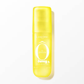 A yellow transparent spray bottle with a soft touch finish, containing a clear liquid, with white text on the front. The bottle is positioned vertically in the center, casting a subtle shadow on the white background. The image is brightly lit from the front, with soft, even artificial lighting.